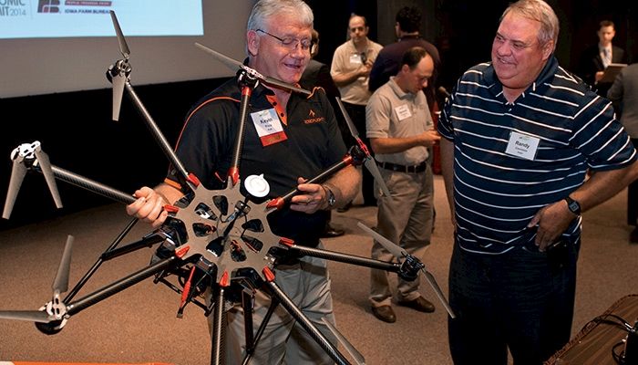 Kevin Price shows Adair County farmer Randy Caviness an octocopter drone.