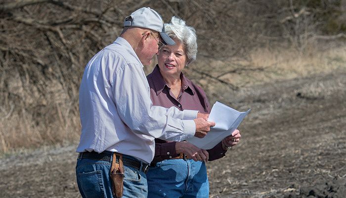 Polk County Farm Bureau members Randy and Carol Miller look over plans for their bioreactor, which was completed this spring. PHOTO/GARY FANDEL 