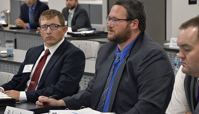 Wright County Farm Bureau member Ethan Lambert, left, listens as Robert Lines, a Floyd County Farm Bureau member, discusses ag issues