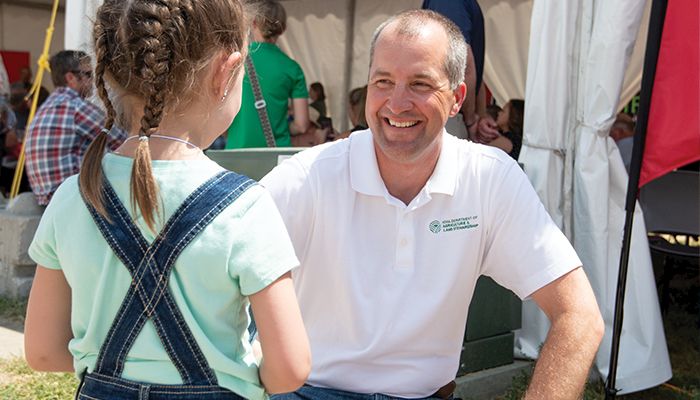 Sawyer Millard, 4, of Alta talks with Iowa Secretary of Agriculture Mike Naig last week during the World Pork Expo 