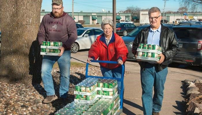 Polk County Farm Bureau members, from left to right, Rob Stewart, Carol Miller and Brad Moeckly delivered food to the Food Bank of Iowa