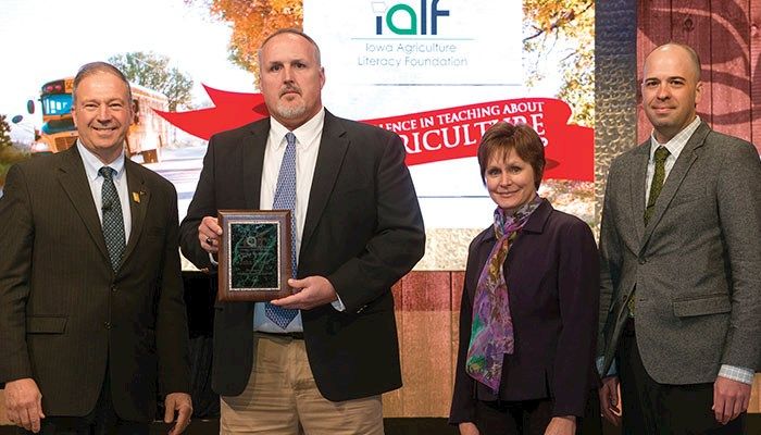 Iowa Farm Bureau President Craig Hill presented John Seiser, a fifth and sixth grade teacher from Northeast Hamilton Community Schools, with the first annual Iowa Excellence in Teaching Agriculture Award