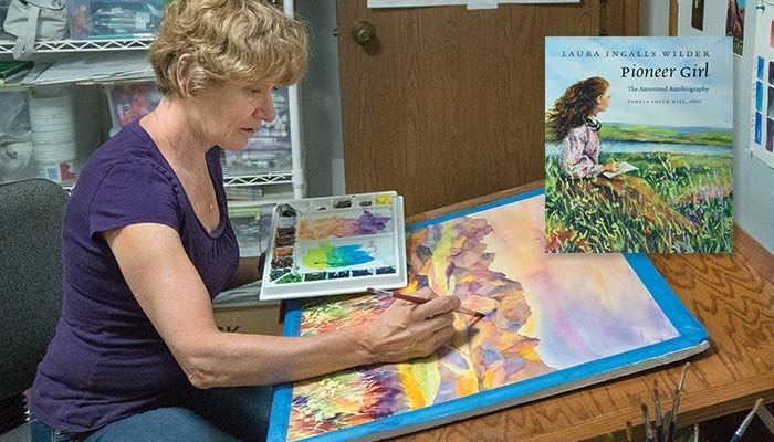 Judy Thompson works in her Orange City studio on her latest watercolor painting. Thompson says she gets her inspiration from the landscapes of the Midwest and Great Plains.