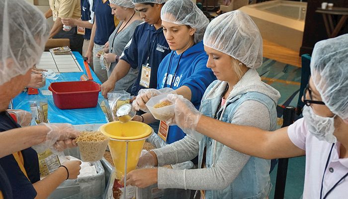 Students from Graceland University and Iowa State University (ISU) packaged macaroni and cheese meals last week at the Iowa Hunger Summit. Photo by Gary Fandel