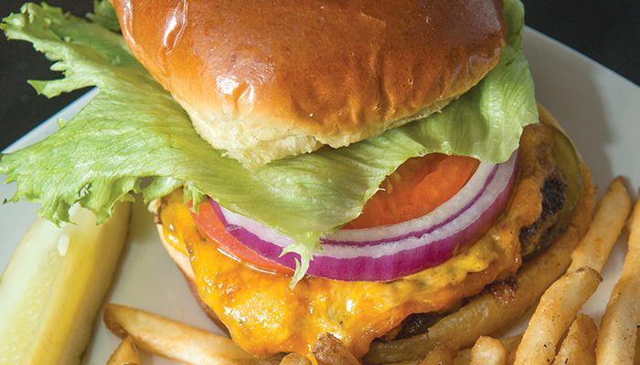 The Surf Burger at the Surf District Rock 'n Roll Grill in Clear Lake features Iowa premium beef, Wisconsin cheddar cheese and "boom boom" sauce on a toasted brioche bun, served with fries.