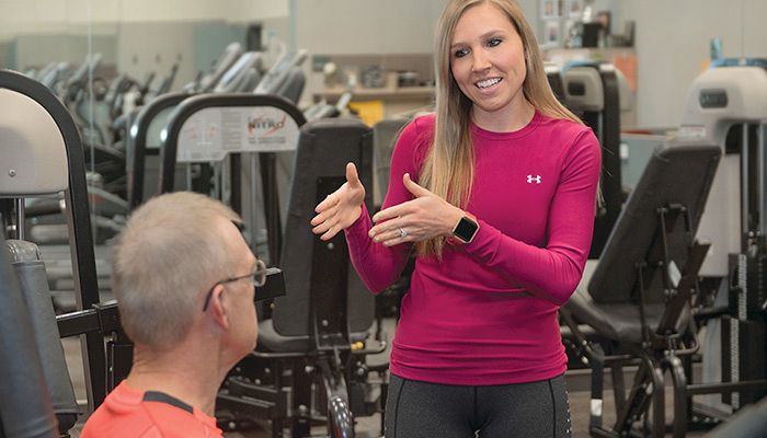 Brittany McKinley, wellness specialist for FBL Financial Group, gives health and fitness advice to employees at the Farm Bureau home office in West Des Moines.