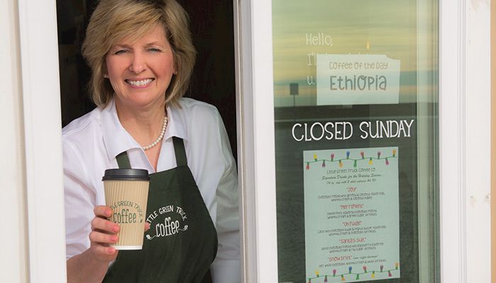 Farm Bureau member Ellen Frank greets customers at the drive-thru window at her family's coffee shop, Little Green Truck Coffee Co. in Auburn.