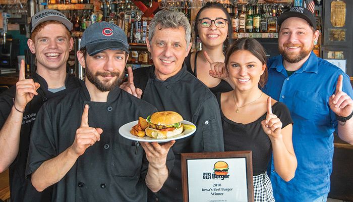 The Cafe Beaudelaire staff, from left, Jacob Hamilton, kitchen manager Tom Otting, owner Claudio Gianello, Brittany Chapman, Lexi Romitti and Nick Bergen celebrate their win.