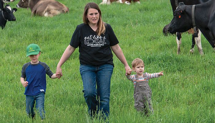 Heather Moore raises her children, Cassidy and Cooper, and her dairy cows at Moore Family Farms in Maquoketa. The family now sells cheese and ice cream straight from their dairy farm.
