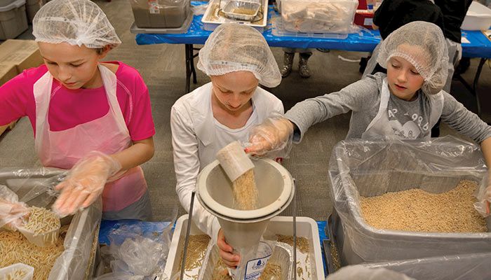 Meals from the Heartland, based in central Iowa, hosts meal packaging events with help from volunteers of all ages. 