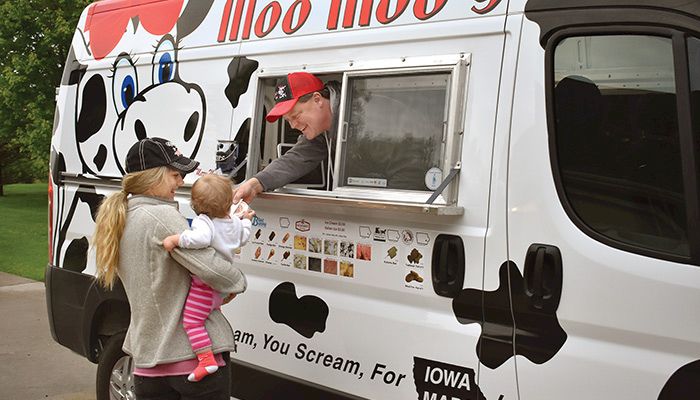 Even family gets a treat. Farm Bureau member Jason Happel serves an ice cream favorite to daughter-in-law and granddaughter