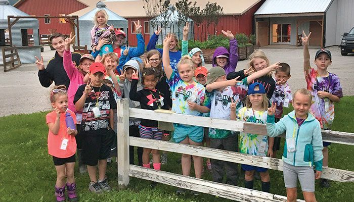 Two inches of rain! Checking the rain gauge is the first activity of the day at Center Grover Orchard Farm Camp — just like on the farm. Below left: Inside lessons are part of the camp line-up, along with the hands-on experience. submitted photo