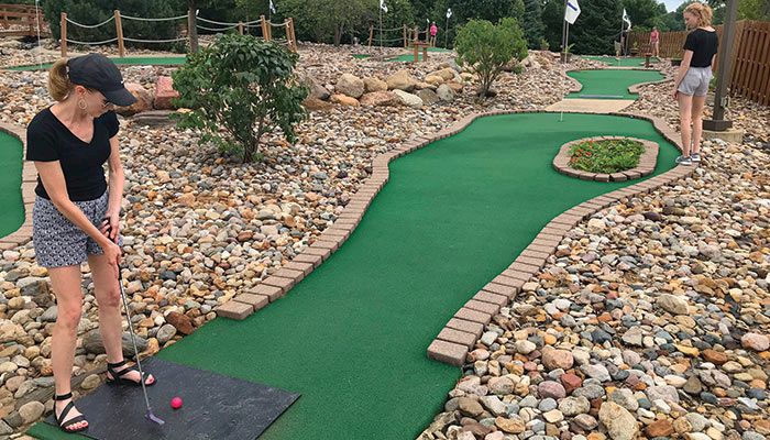 A mini-golf player sets up her shot at the popular Field of Greens mini-golf course at Toad Valley Golf in Pleasant Hill.