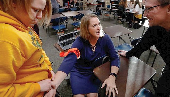 Dr. Rick Sidwell, right, helps teach volunteers at a recent "Stop the Bleed" training session. 