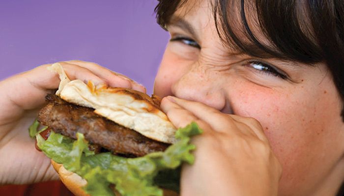 Boy eating burger