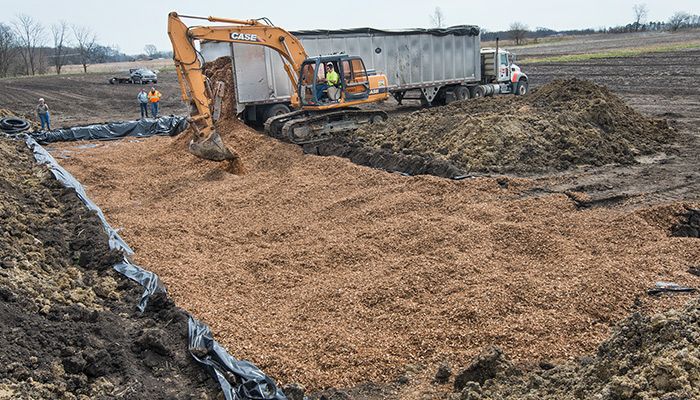 Farm Bureau member Jacob Handsaker fills a newly constructed bioreactor on Randy and Carol Miller's farm near Ankeny. 