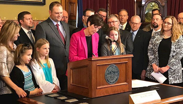 Governor Kim Reynolds signs Senate File 2349