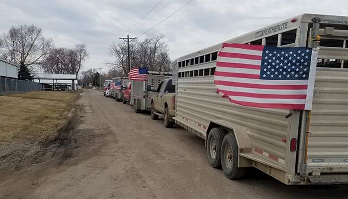 Adam Glienke, a Cherokee County Farm Bureau leader, and his neighbors delivered 600 small hay bales, enough to fill five large trailers, to Nebraska livestock farmers devastated by flooding. 