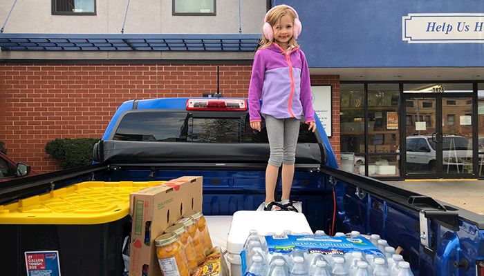 Andrew Wheeler and his daughter drop off a donation at the local food bank