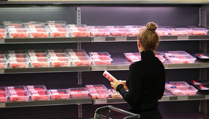Grocery shopper looking at meat case