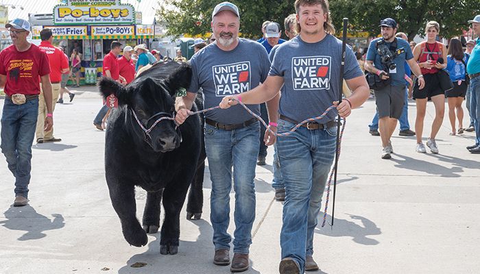 Iowa Farm Bureau Federation President Brent Johnson and Chase Anderson of Boone County lead The Admiral, sponsored by Central Iowa County Farm Bureaus, into the showring at the 40th annual Iowa Governor’s Charity Steer Show 