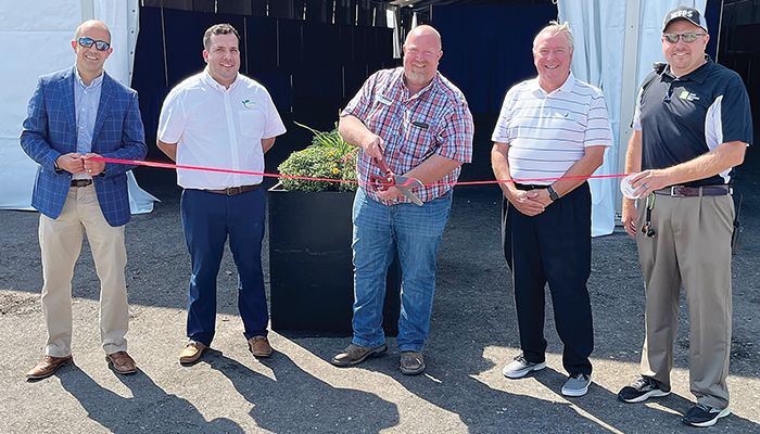 Cutting the ribbon on the new asphalt base in the Varied Industries Tent at the Farm Progress Show 