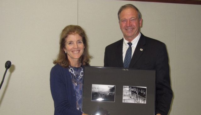 Iowa Farm Bureau President Craig Hill offered a special gift to U.S. Ambassador Caroline Kennedy: framed photographs of the Yamanashi hog lift.