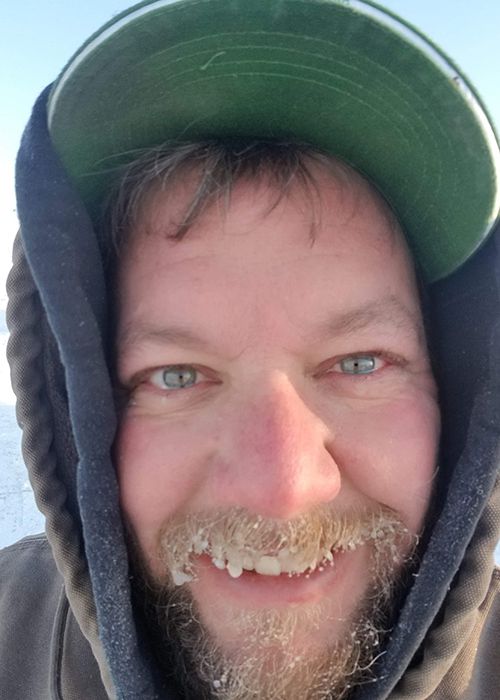 Linn County farmer Jason Russell braves the cold to care for his pigs and other livestock.