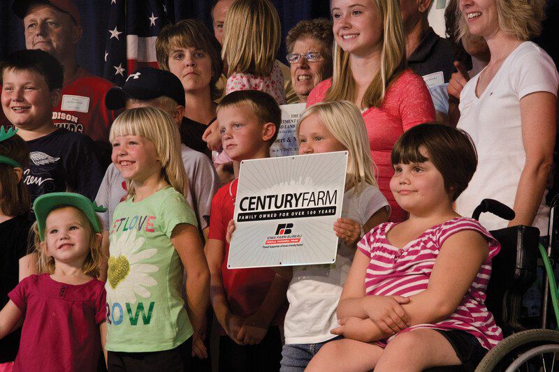 crowd holding up Century Farm award