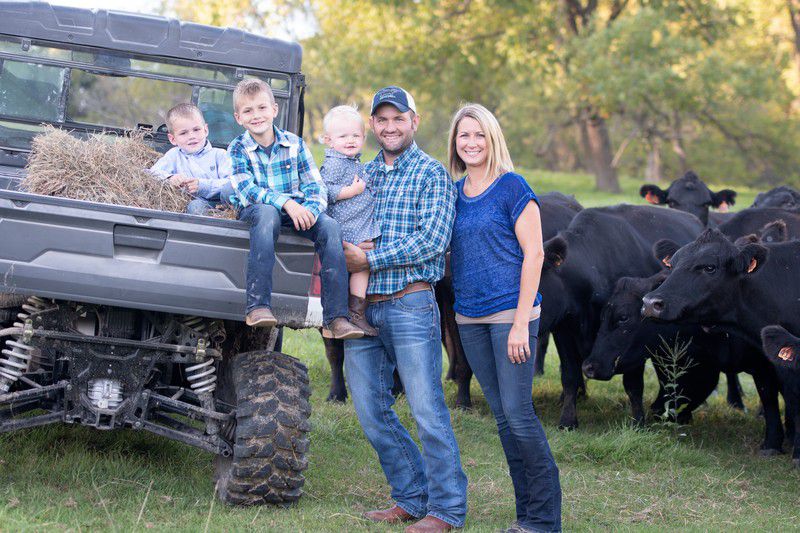 family at farm with cows