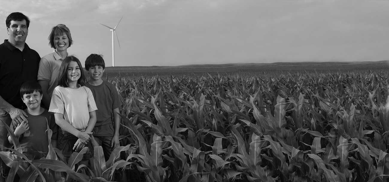 Family standing in corn field.