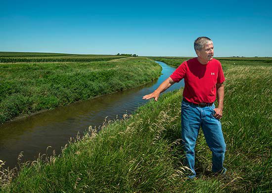 Farmer discussing water runoffs.