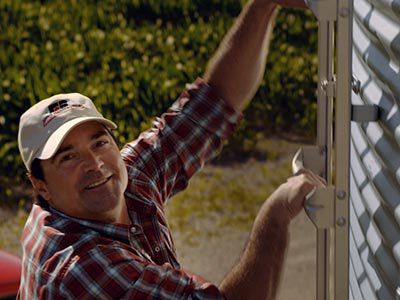 Farmer climbing a silo ladder.